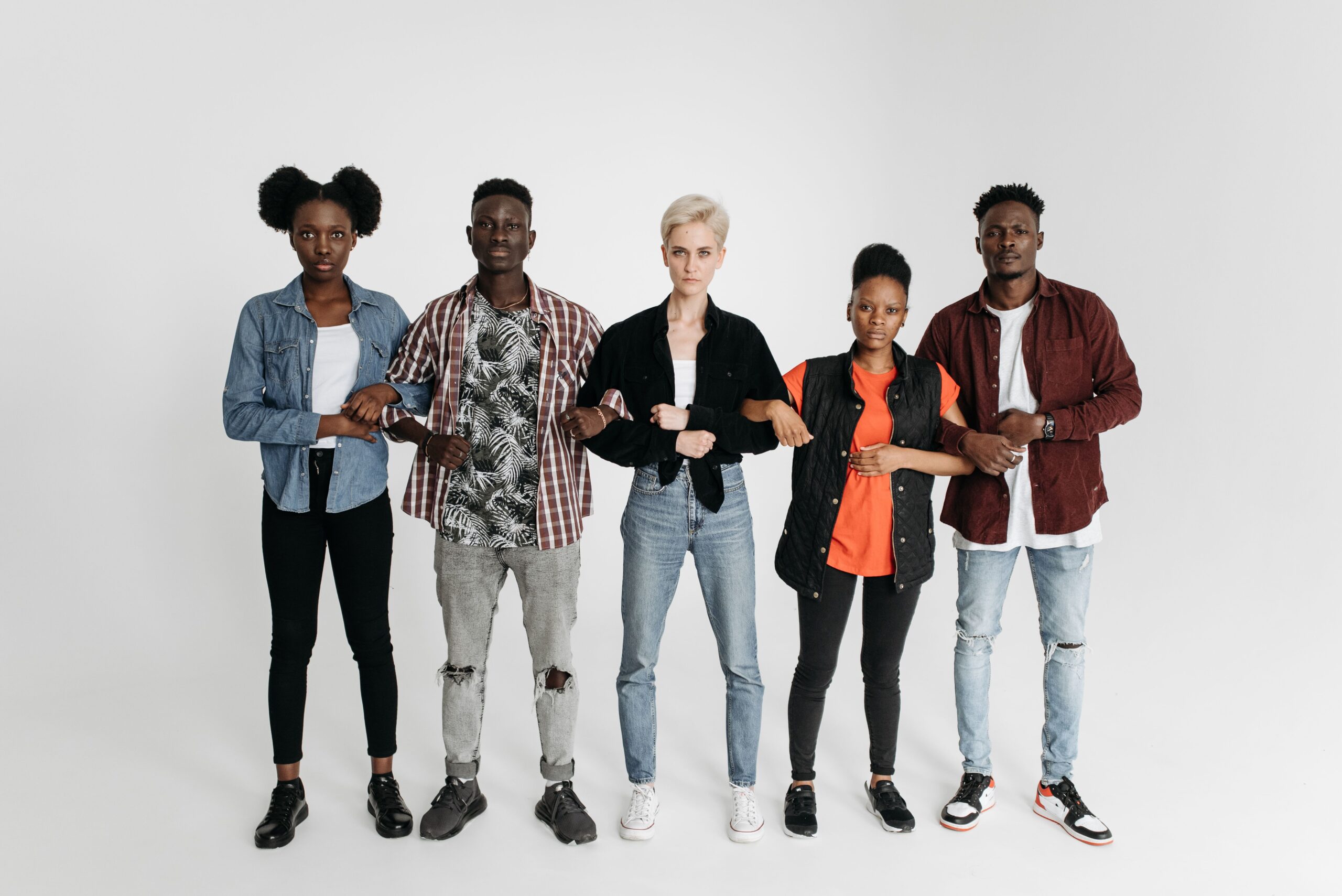 About A diverse group of young adults united and holding hands, symbolizing solidarity and activism.